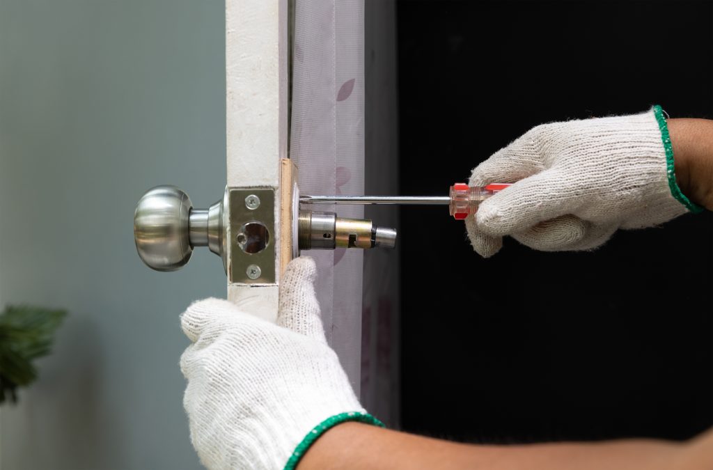 Locksmith,On,Wood,Door,With,Screwdriver,For,Repair,Or,Fix