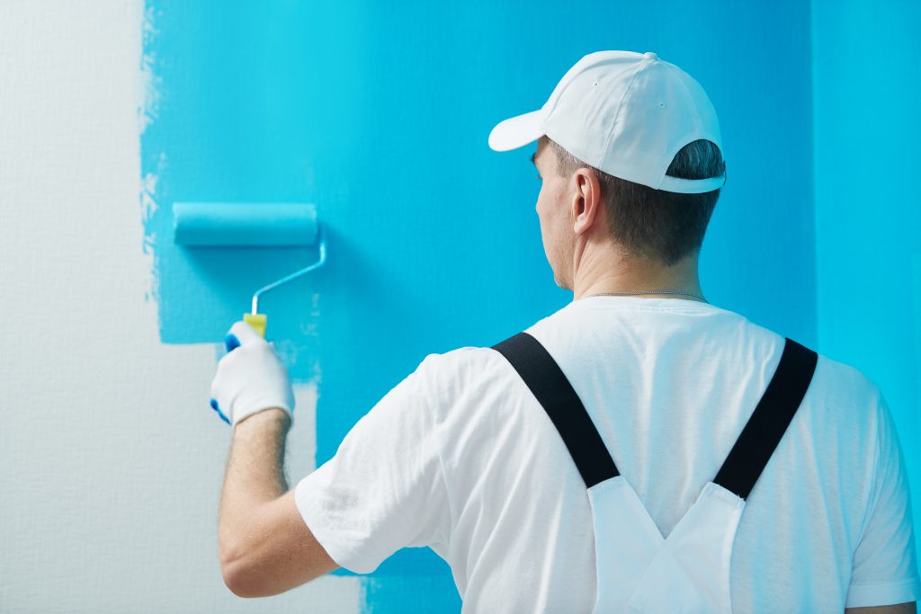 Painter,Worker,With,Roller,Painting,Wall,Surface,Into,Color