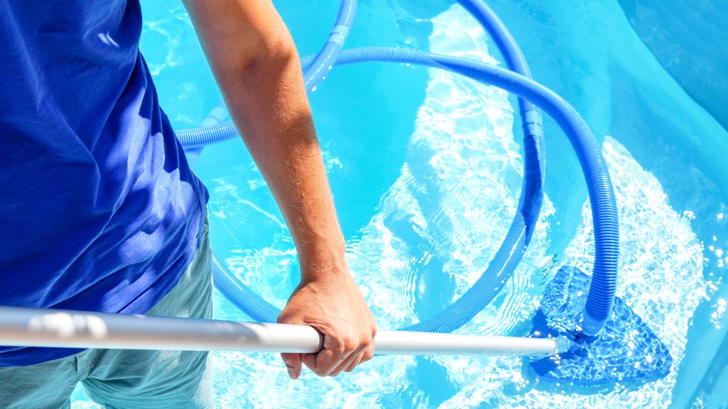 Swimming,Pool,Cleaning.,A,Man,Is,Cleaning,The,Pool.,Service